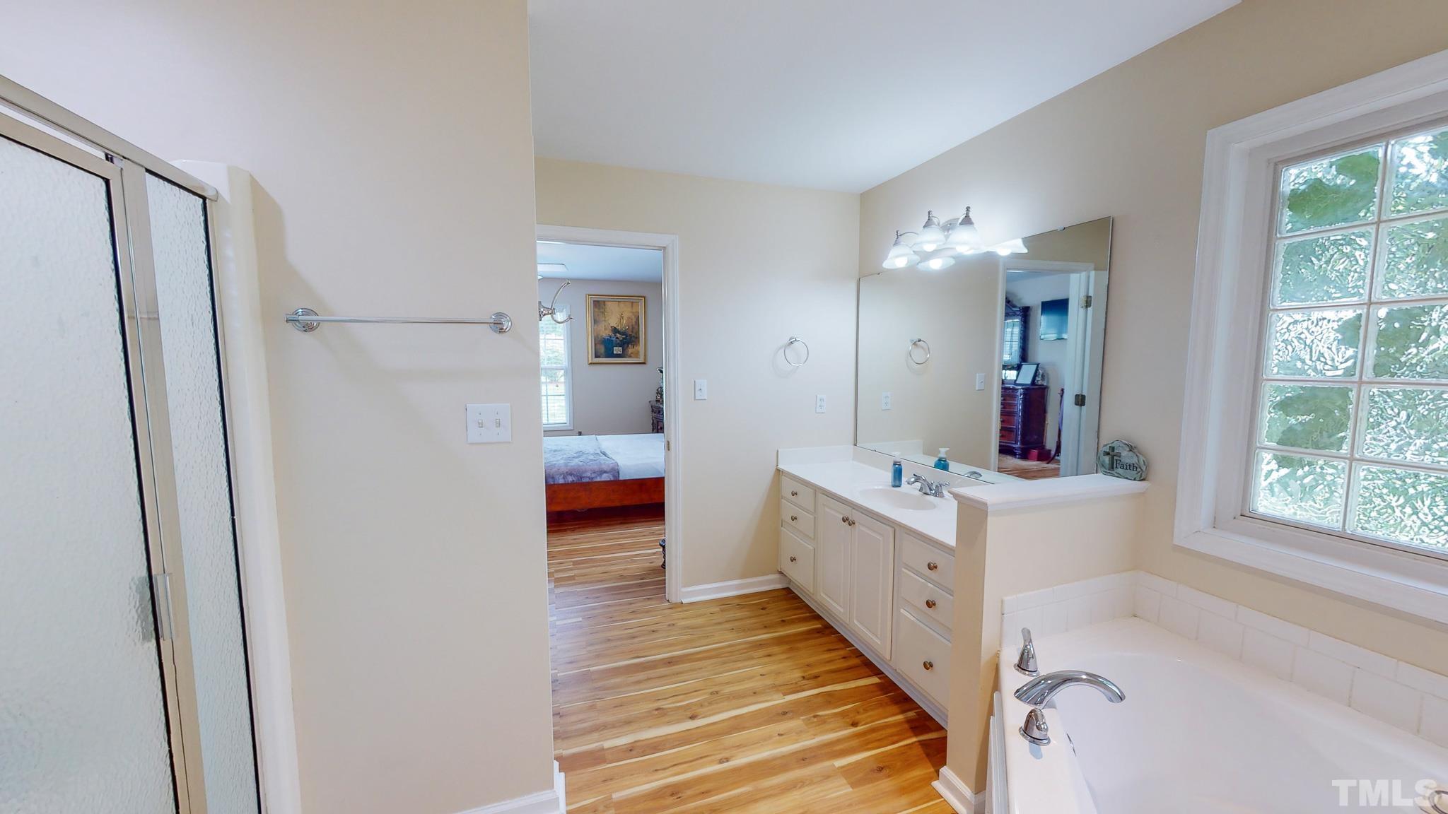159 Punch Hill Farm Road Rougemont, NC 27572 - Photo 16 of 43 a bathroom with a sink a mirror and a bathtub