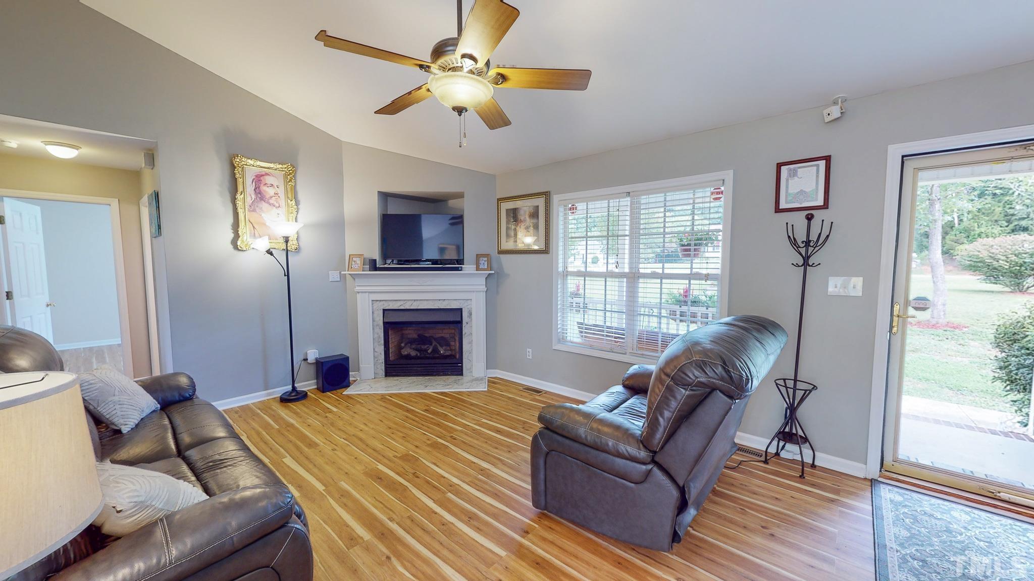 159 Punch Hill Farm Road Rougemont, NC 27572 - Photo 19 of 43 a living room with furniture a fireplace and a flat screen tv