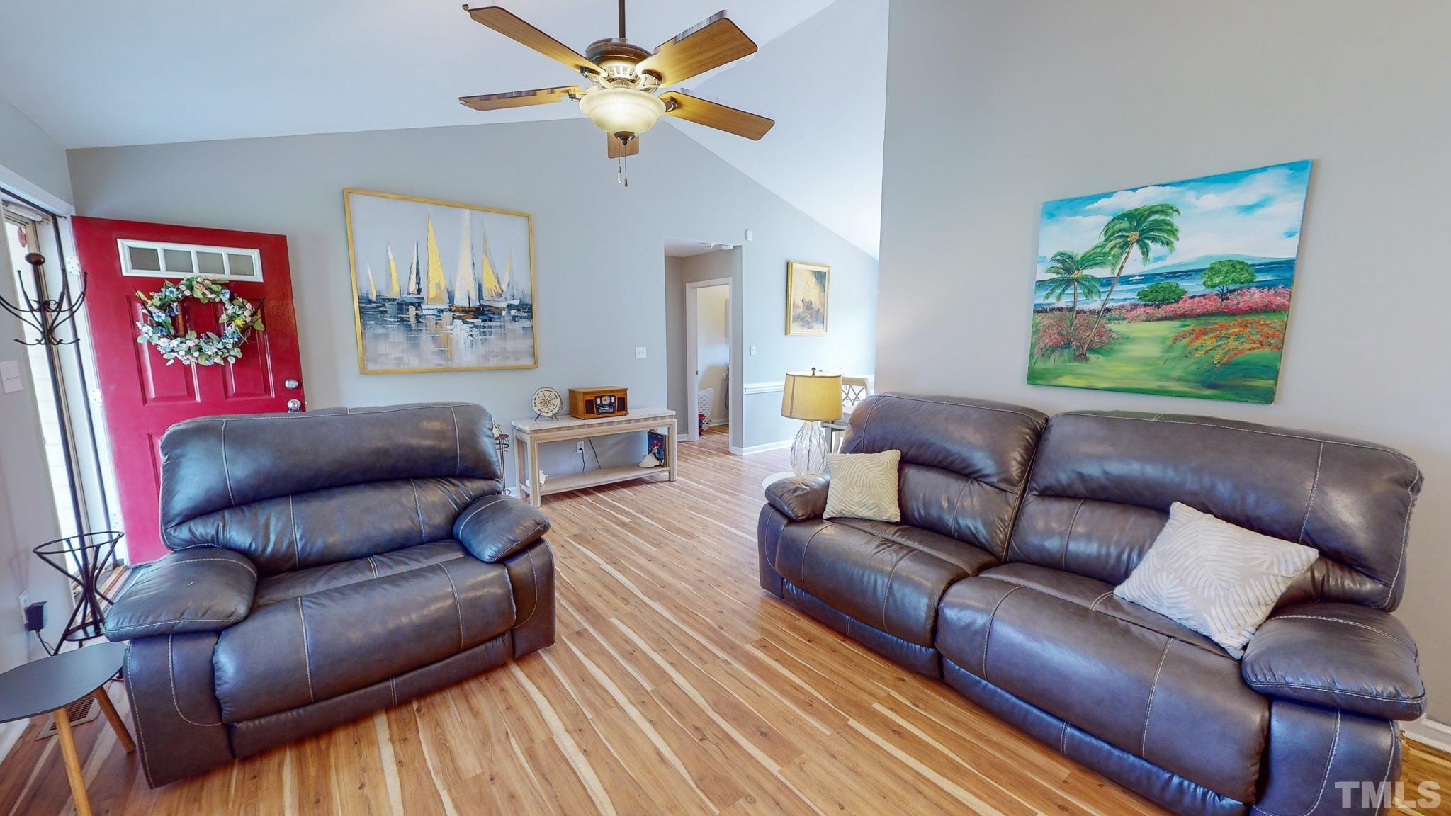 159 Punch Hill Farm Road Rougemont, NC 27572 - Photo 20 of 43 a living room with furniture a couch and paintings on the wall