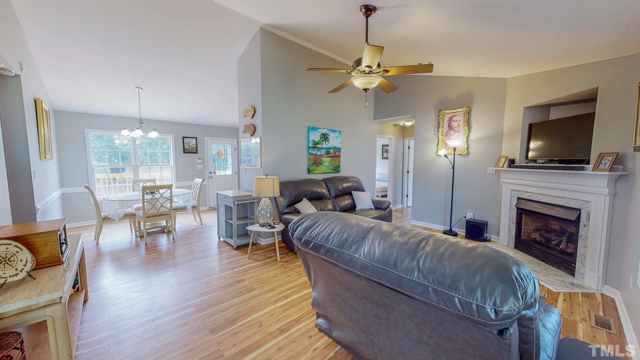 159 Punch Hill Farm Road Rougemont, NC 27572 - Photo 2 of 43 a living room with furniture a flat screen tv and a fireplace