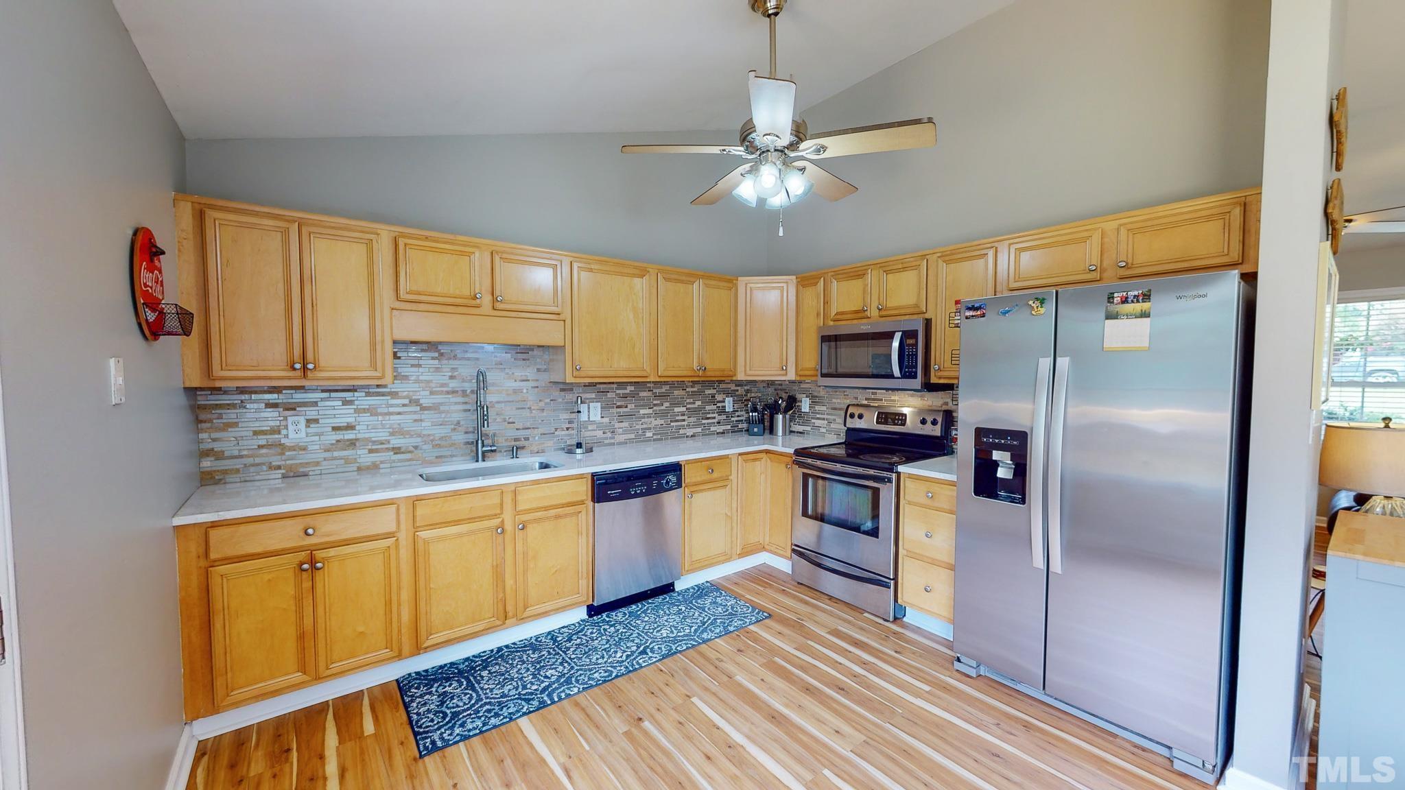 159 Punch Hill Farm Road Rougemont, NC 27572 - Photo 24 of 43 a kitchen with stainless steel appliances granite countertop a refrigerator a sink dishwasher a stove with wooden cabinets and floor