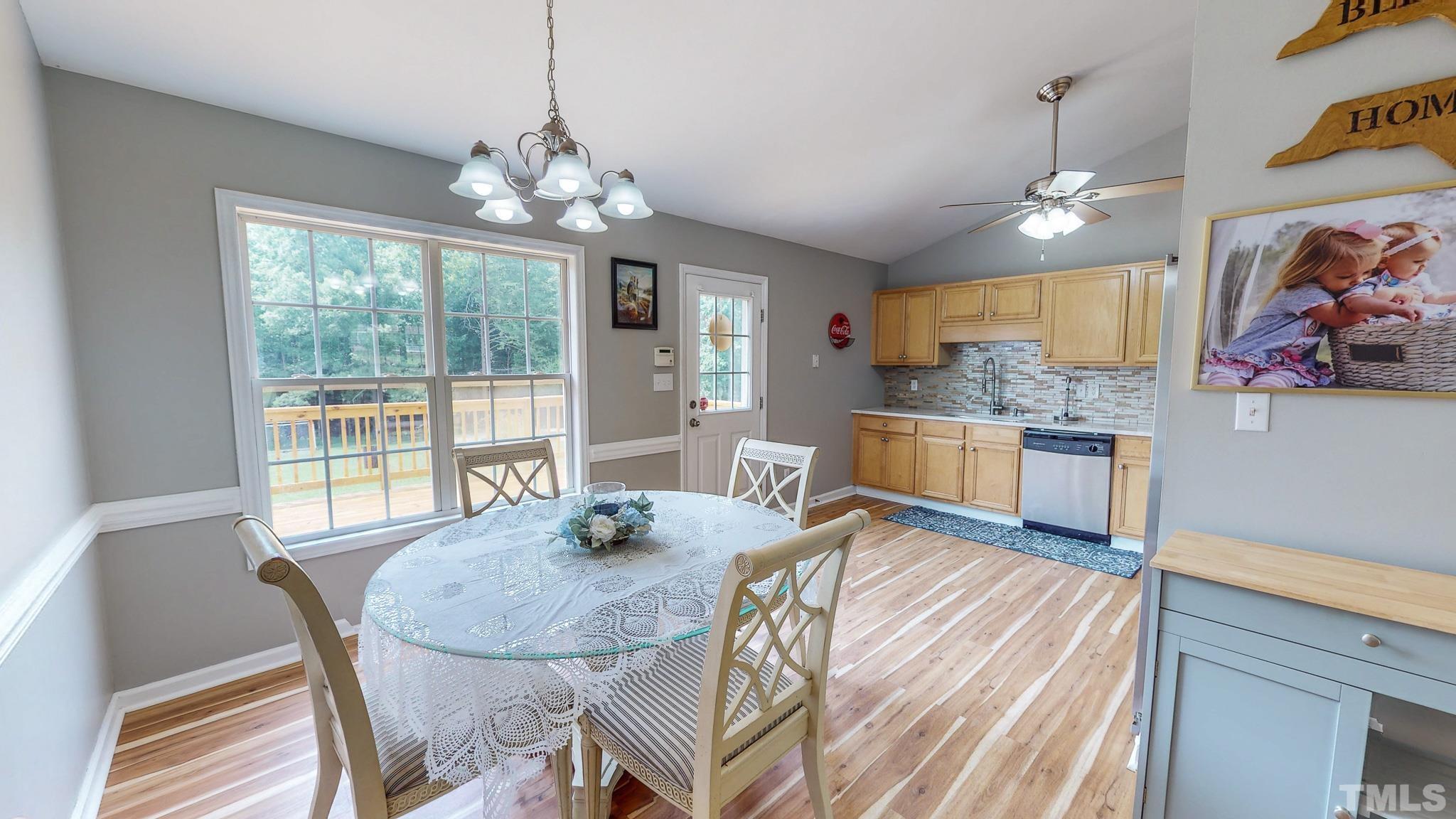 159 Punch Hill Farm Road Rougemont, NC 27572 - Photo 3 of 43 a view of a dining room with furniture a chandelier and wooden floor