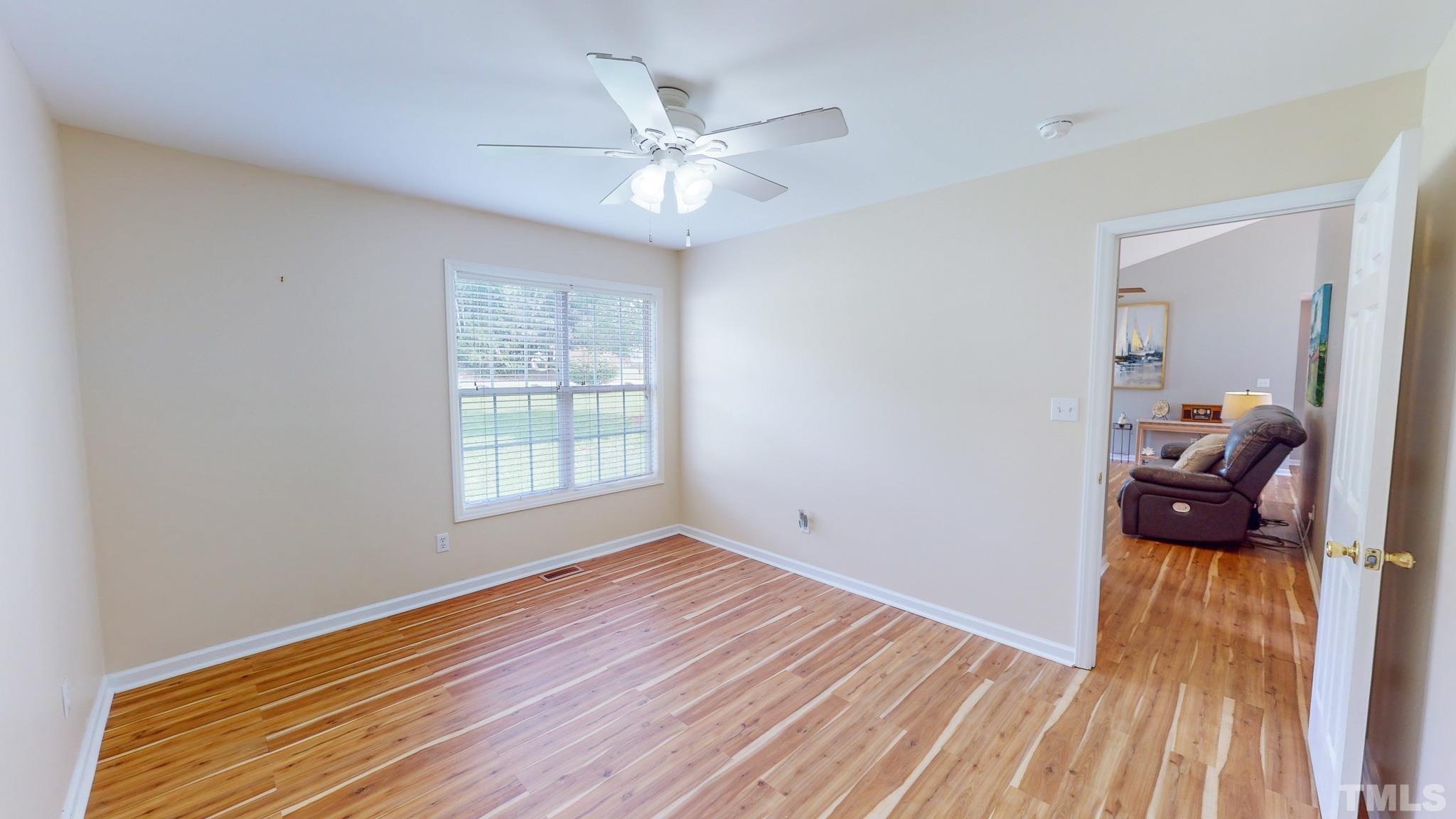 159 Punch Hill Farm Road Rougemont, NC 27572 - Photo 34 of 43 a view of a livingroom with wooden floor and a ceiling fan