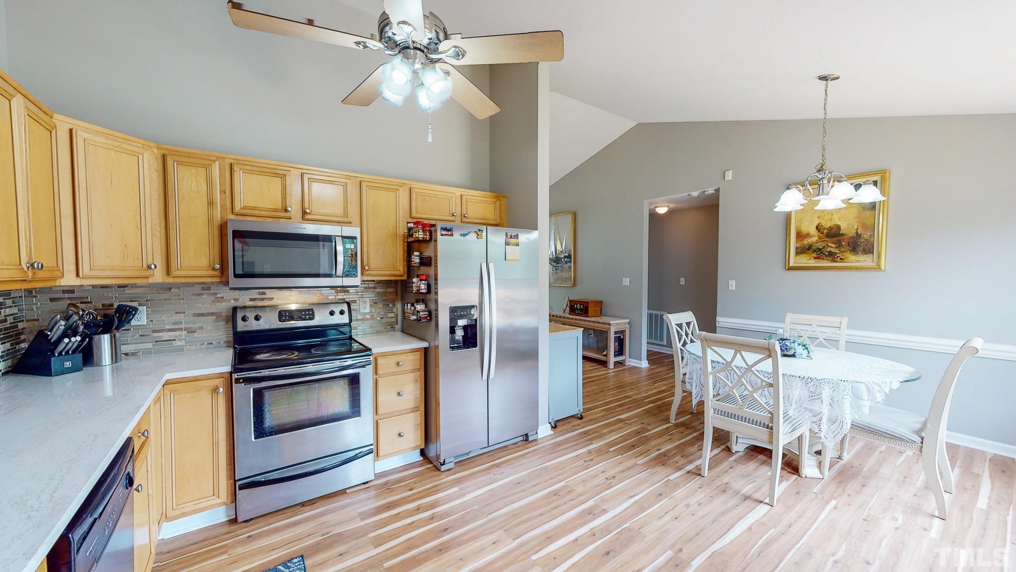 159 Punch Hill Farm Road Rougemont, NC 27572 - Photo 4 of 43 a kitchen with stainless steel appliances a dining table chairs stove and refrigerator