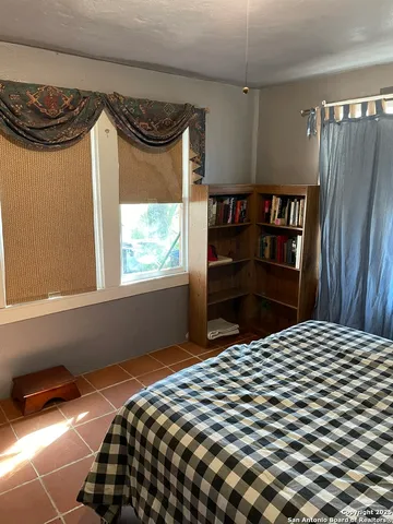 a bedroom with a bed and a window