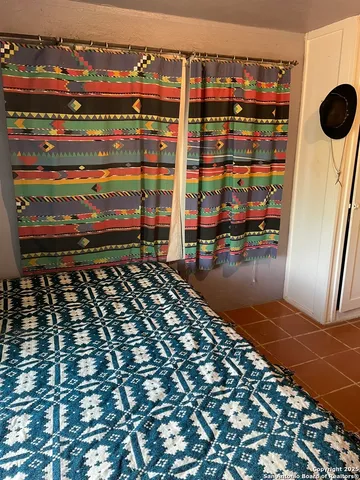 a view of a livingroom with wooden floor and a ceiling fan