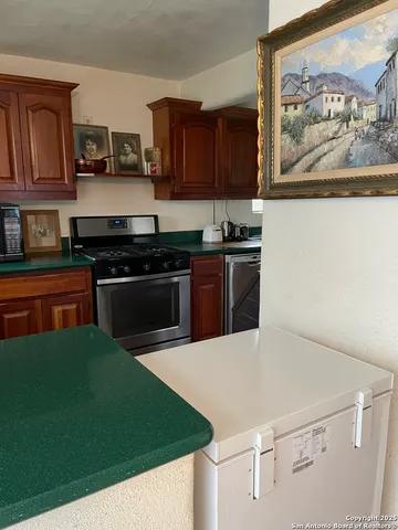 a kitchen with a sink and a stove top oven