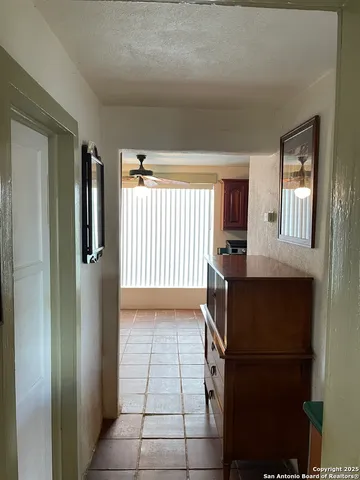 a living room with furniture a fireplace and a floor to ceiling window
