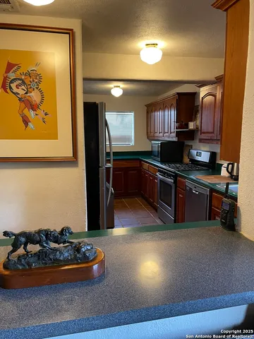 a kitchen with stainless steel appliances granite countertop a stove and a sink