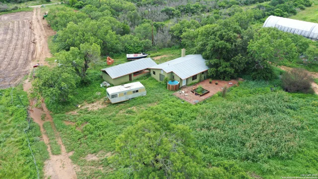 an aerial view of a house with outdoor space and street view