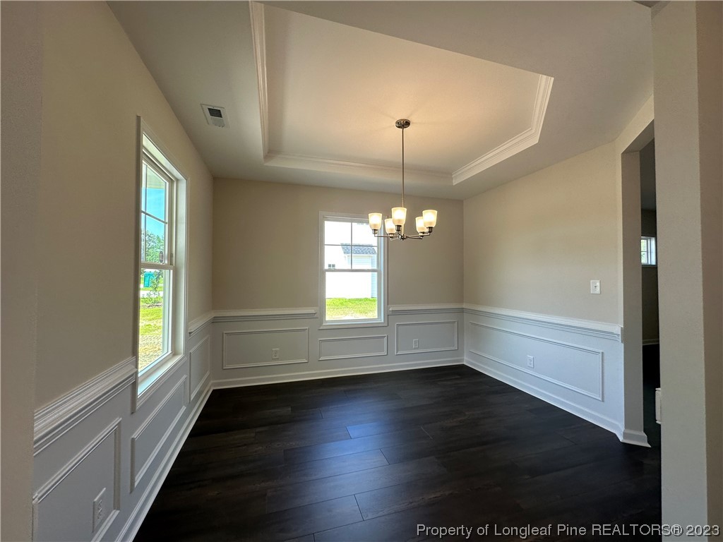 1012 Minnie Hall Road Roseboro, NC 28382 - Photo 3 of 38 an empty room with wooden floor and windows