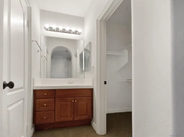 a bathroom with a double vanity sink and a mirror