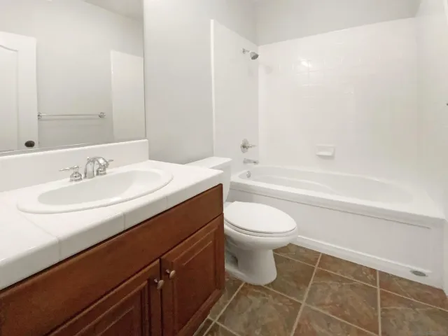 a bathroom with a sink a toilet and bathtub