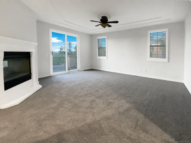 a view of a livingroom with a ceiling fan and window
