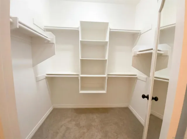 a view of a livingroom with a ceiling fan and window