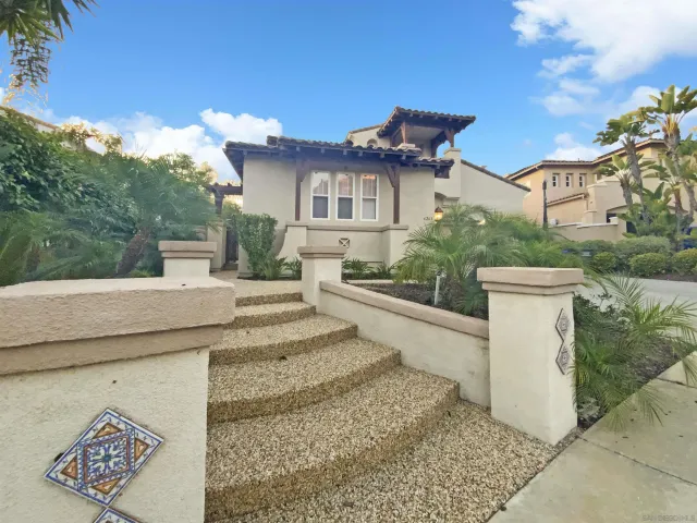 a view of a white house with a sink and yard
