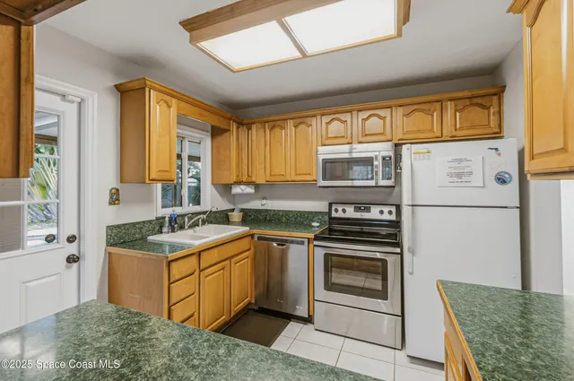 a view of an entryway with a chandelier fan