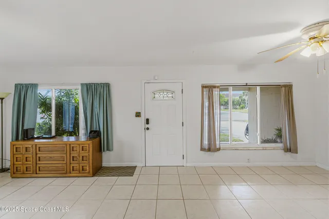 a view of a room with a fan and wooden floor