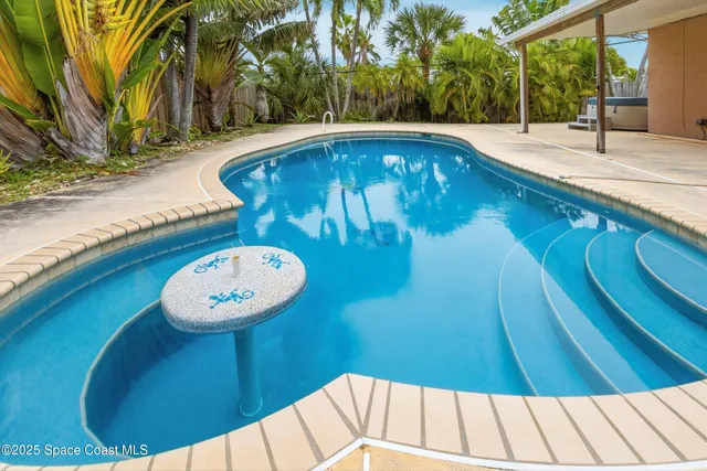 a view of a swimming pool with a patio