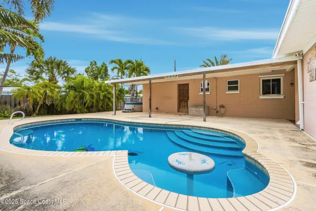 a view of a swimming pool with chairs