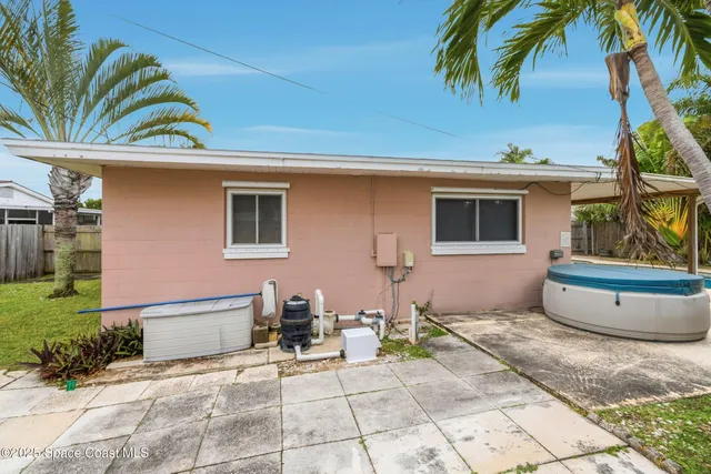 a view of a chair and table in front of a house
