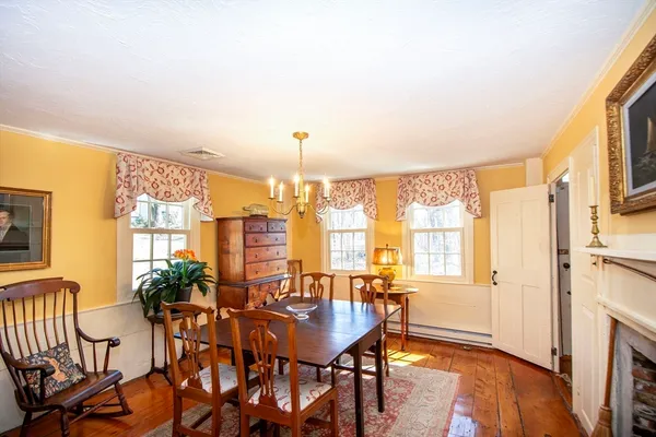 a view of a a dining room with furniture window and wooden floor