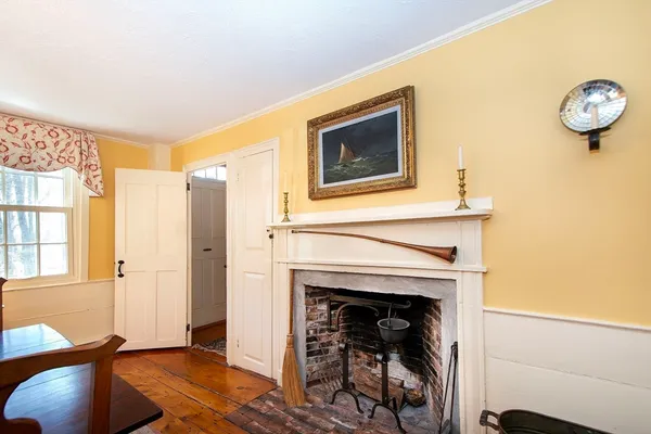 a view of a livingroom with a fireplace and window