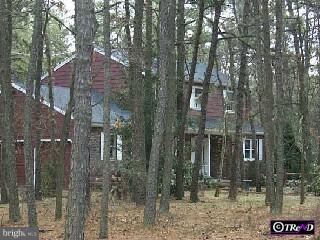 a view of a brick house next to a yard