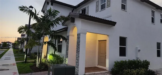 front view of a house with a tree