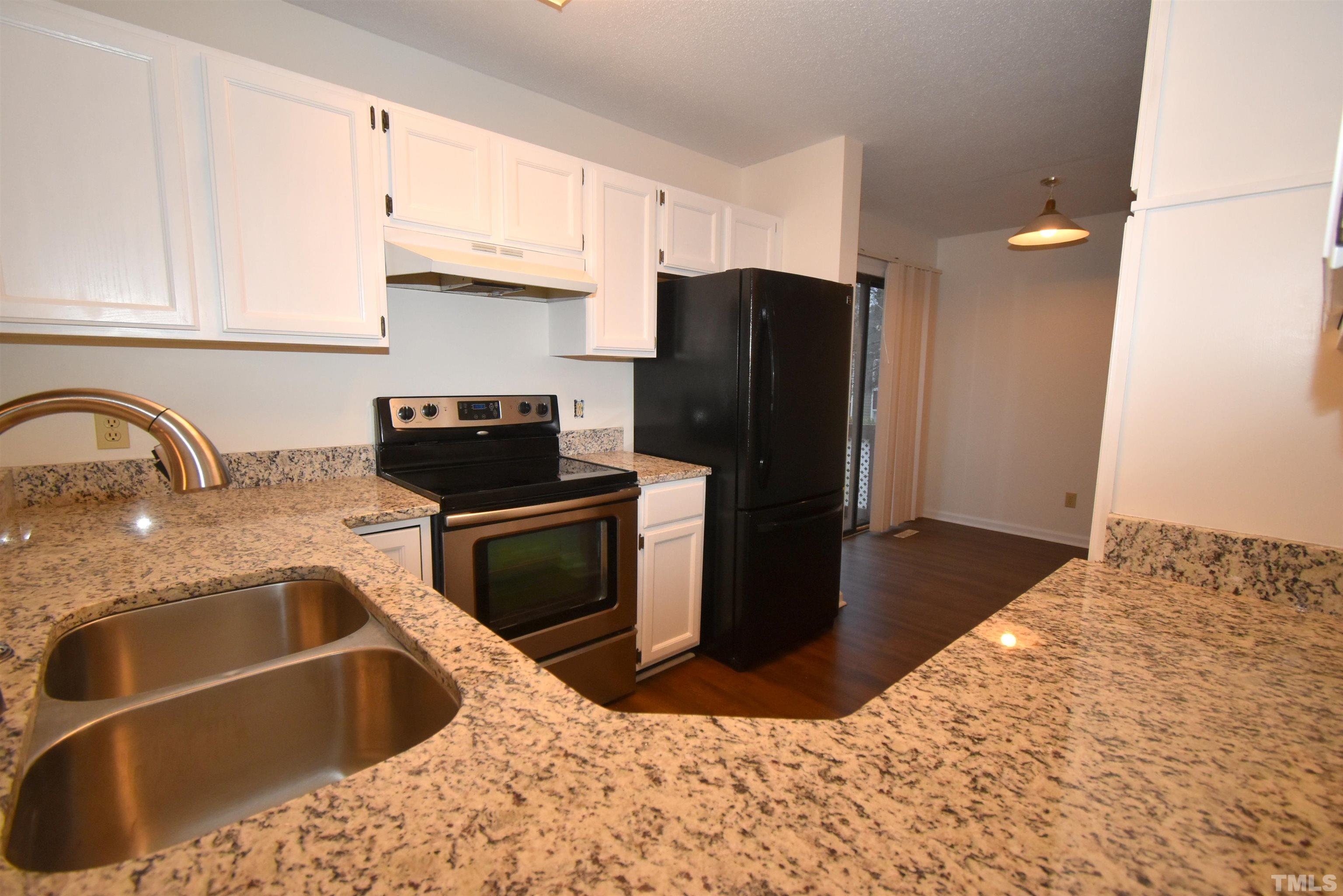 625 Windsong Lane Durham, NC 27713 - Photo 12 of 34 a kitchen with stainless steel appliances granite countertop a sink stove and refrigerator