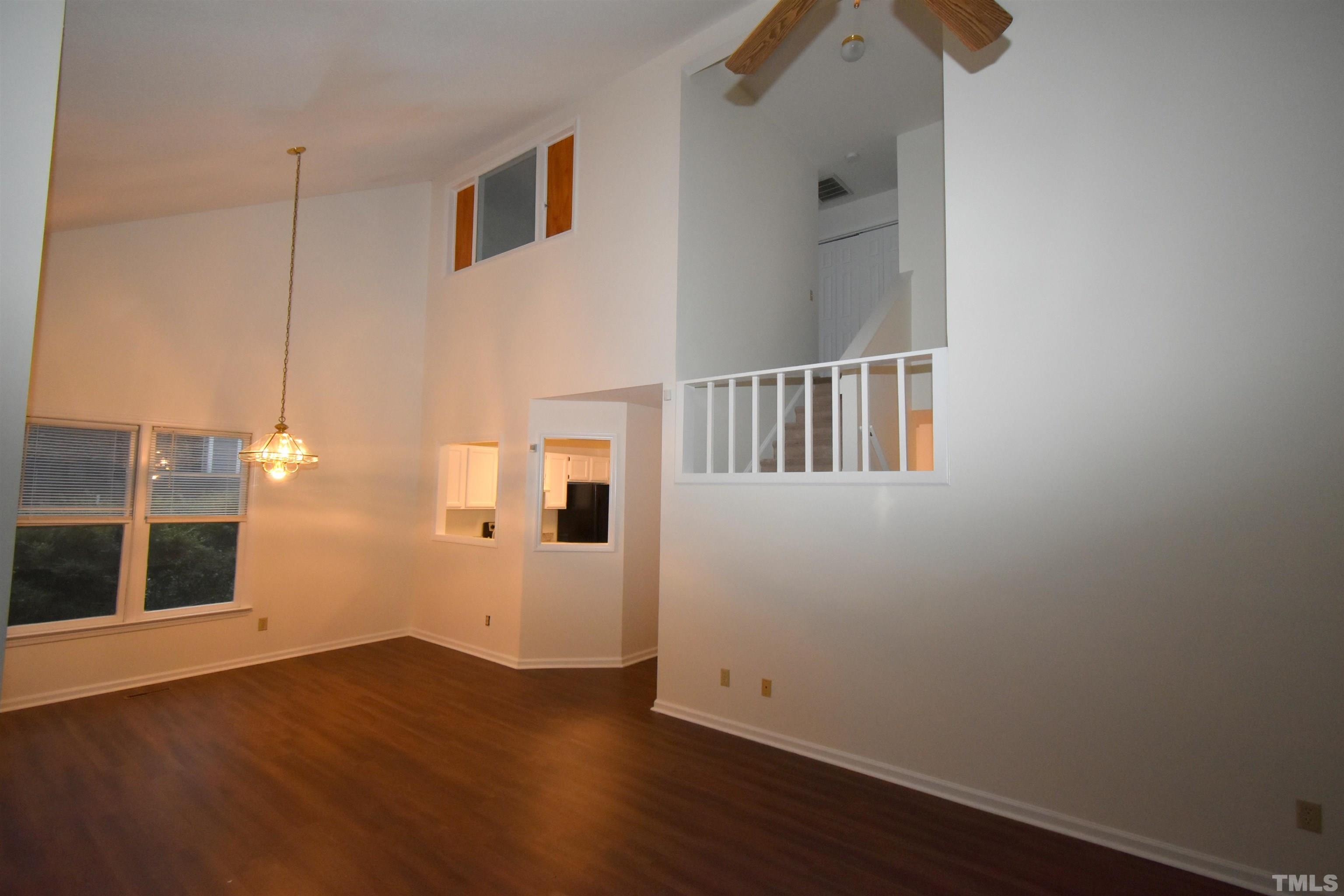 625 Windsong Lane Durham, NC 27713 - Photo 14 of 34 an empty room with wooden floor and windows