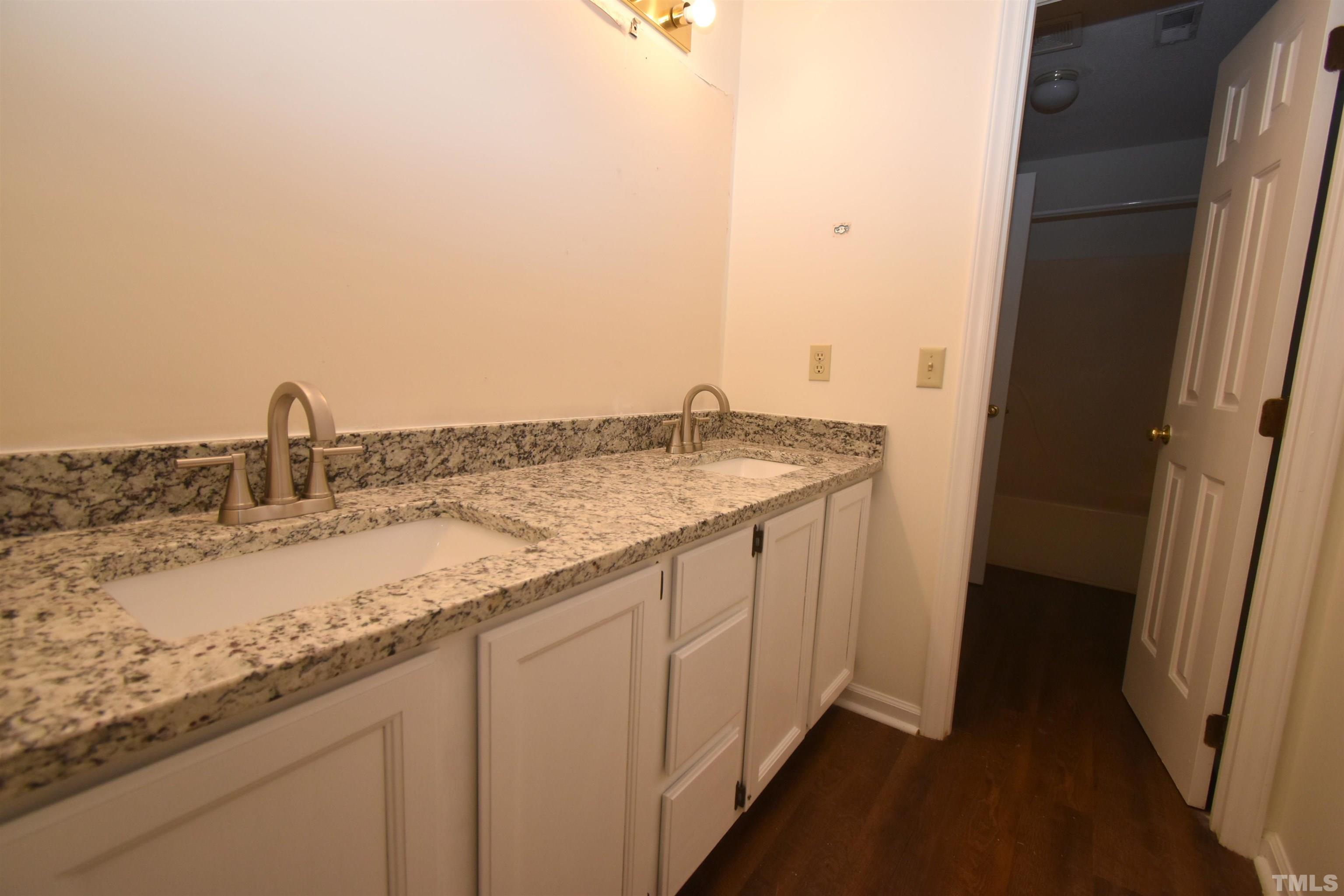 625 Windsong Lane Durham, NC 27713 - Photo 17 of 34 a bathroom with a granite countertop sink and a mirror