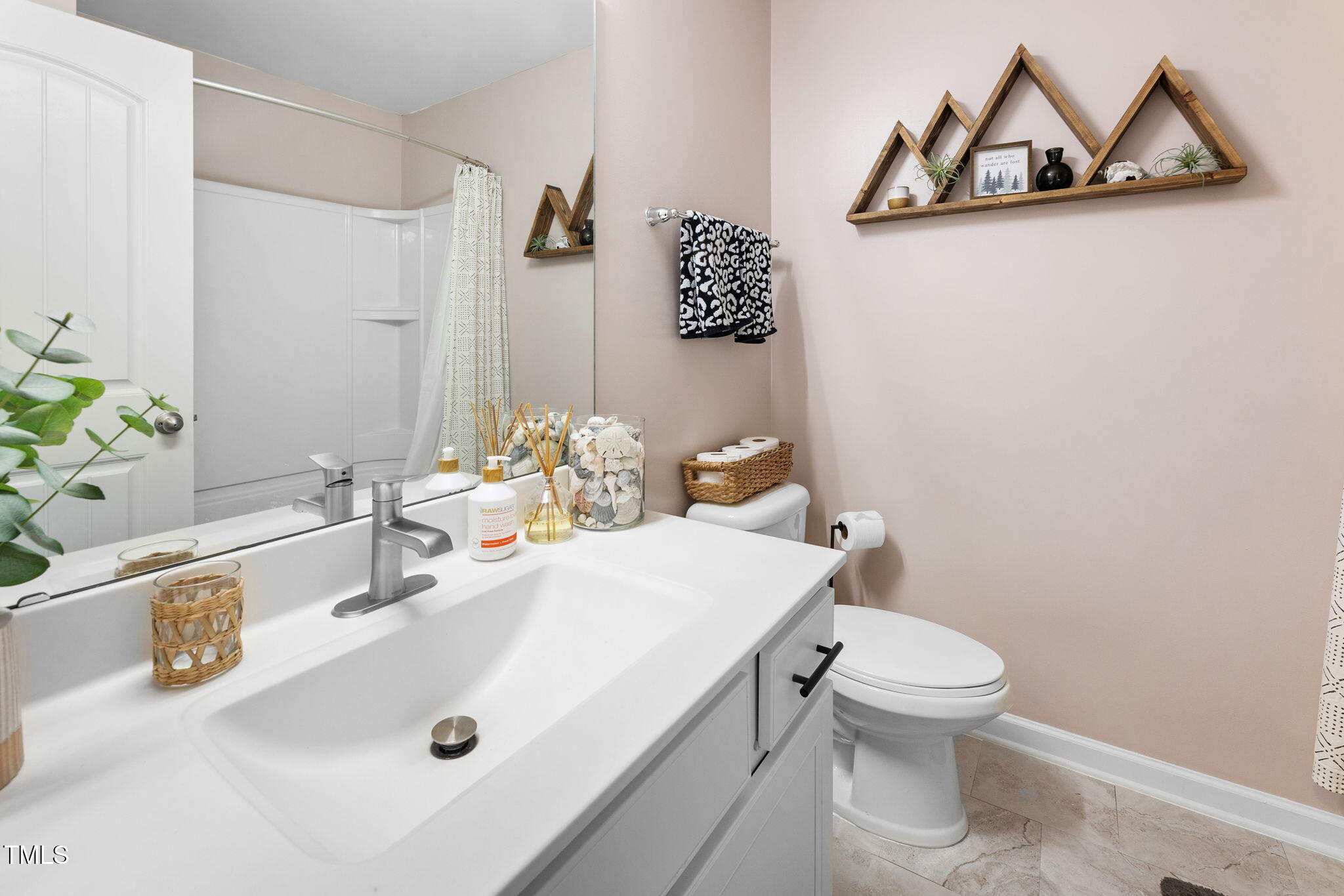 7807 Elmshire Way Raleigh, NC 27616 - Photo 26 of 32 a bathroom with a sink a toilet and mirror