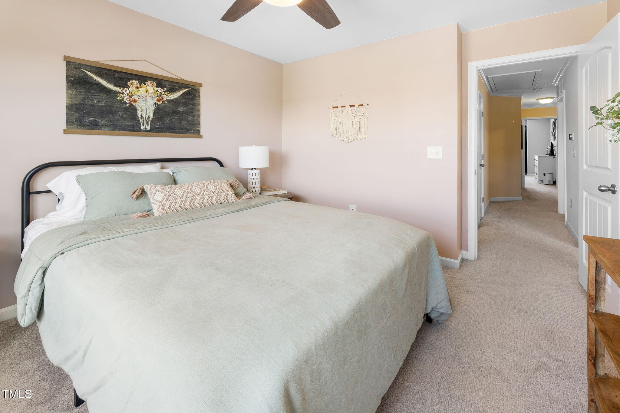7807 Elmshire Way Raleigh, NC 27616 - Photo 30 of 32 a spacious bedroom with a bed and a painting on the wall