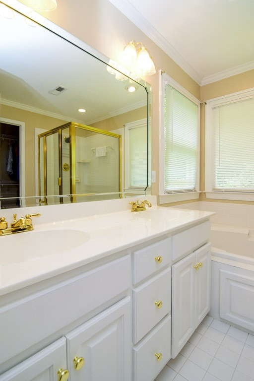 4600 Salem Ridge Road Holly Springs, NC 27540 - Photo 15 of 25 Double vanity sinks in the master bathroom with ample storage and counter top space. The master bath has a well sized separate shower and jetted tub, perfect for relaxing after a long day at work. Master Bath/Spa