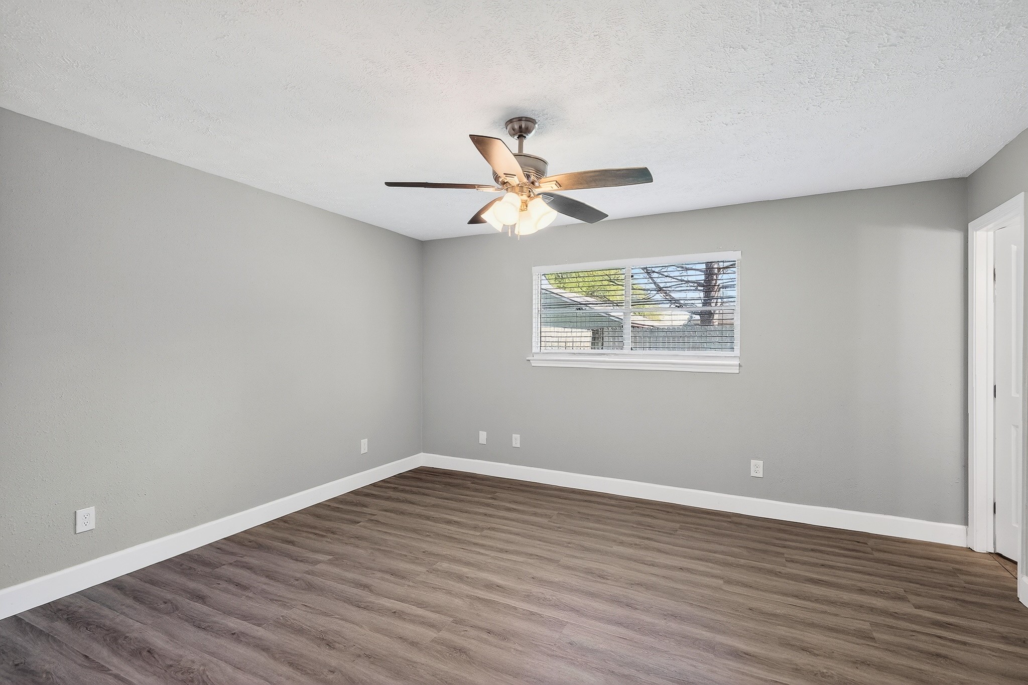 2510 Marble Falls Drive Spring, TX 77373 - Photo 12 of 26 a view of an empty room with wooden floor and a ceiling fan