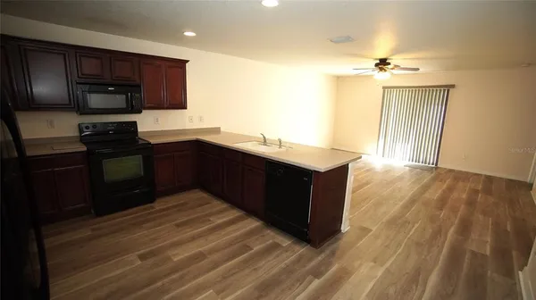 a kitchen with a sink and wooden cabinets