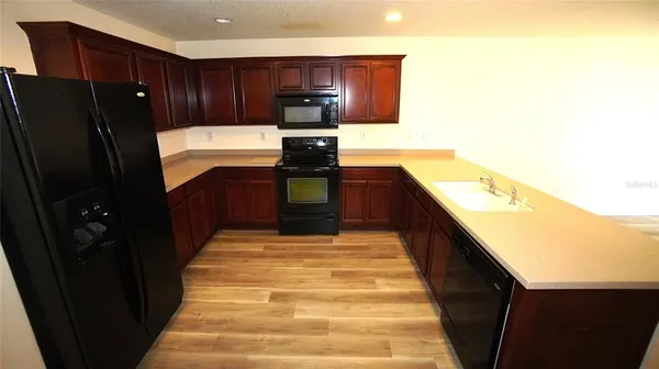 a kitchen with stainless steel appliances granite countertop a refrigerator and a stove