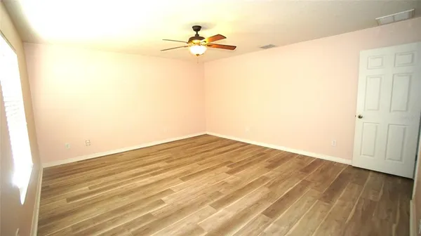 a view of a room with wooden floor