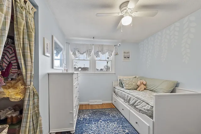 a bedroom with a bed and ceiling fan