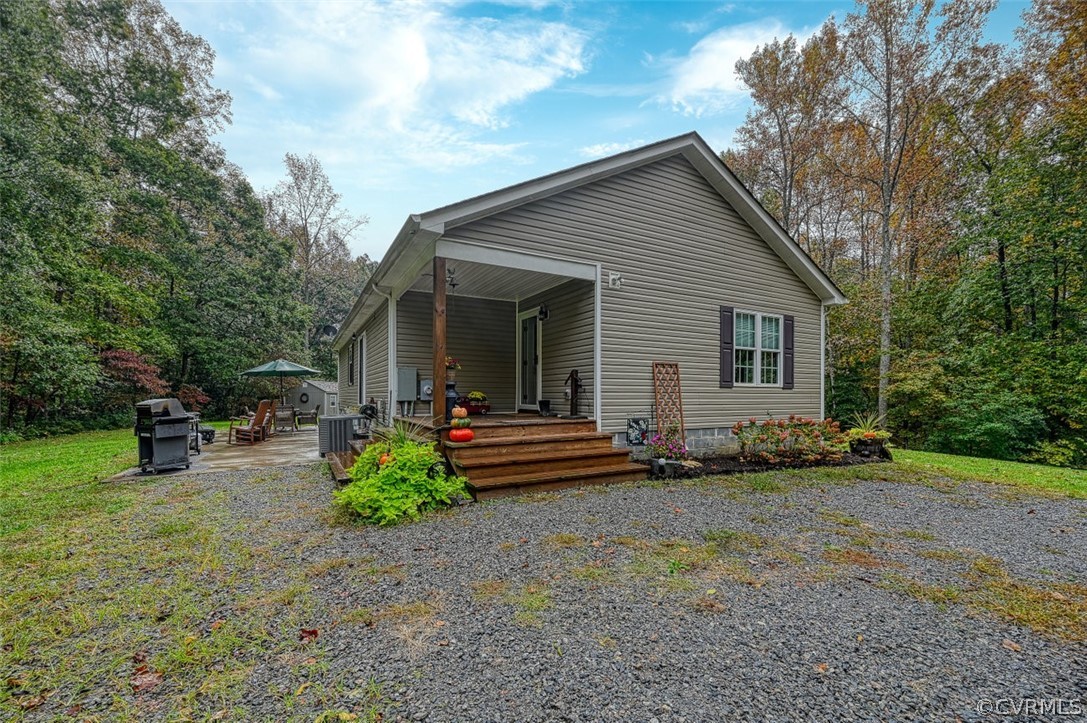 5764 Community House Road Columbia, VA 23038 - Photo 13 of 48 a view of house with backyard and seating area