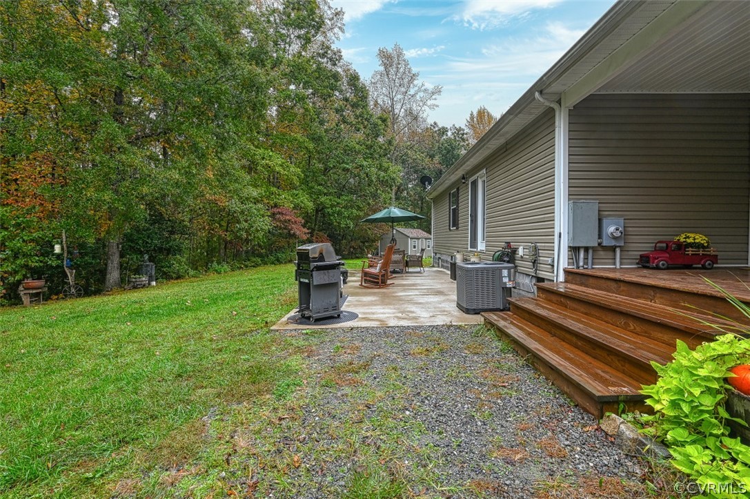 5764 Community House Road Columbia, VA 23038 - Photo 15 of 48 a view of a back yard with a bench