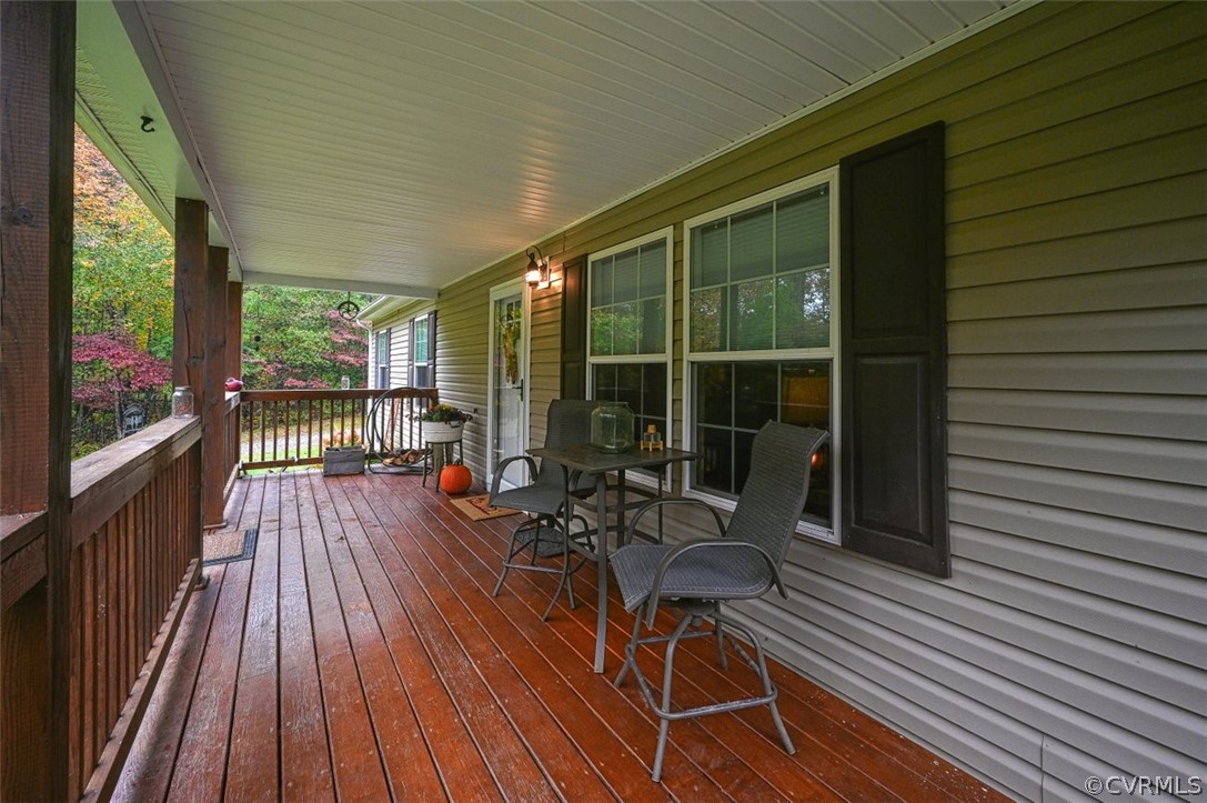 5764 Community House Road Columbia, VA 23038 - Photo 18 of 48 a view of balcony with chairs and wooden floor