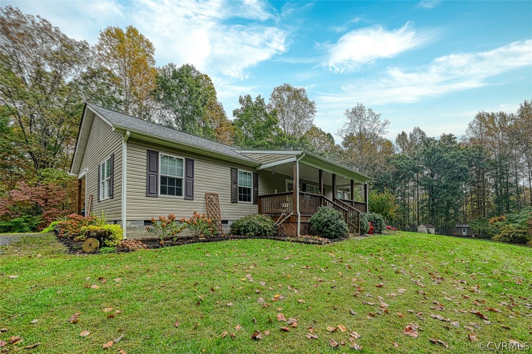 5764 Community House Road Columbia, VA 23038 - Photo 2 of 48 a view of a backyard with plants and large trees