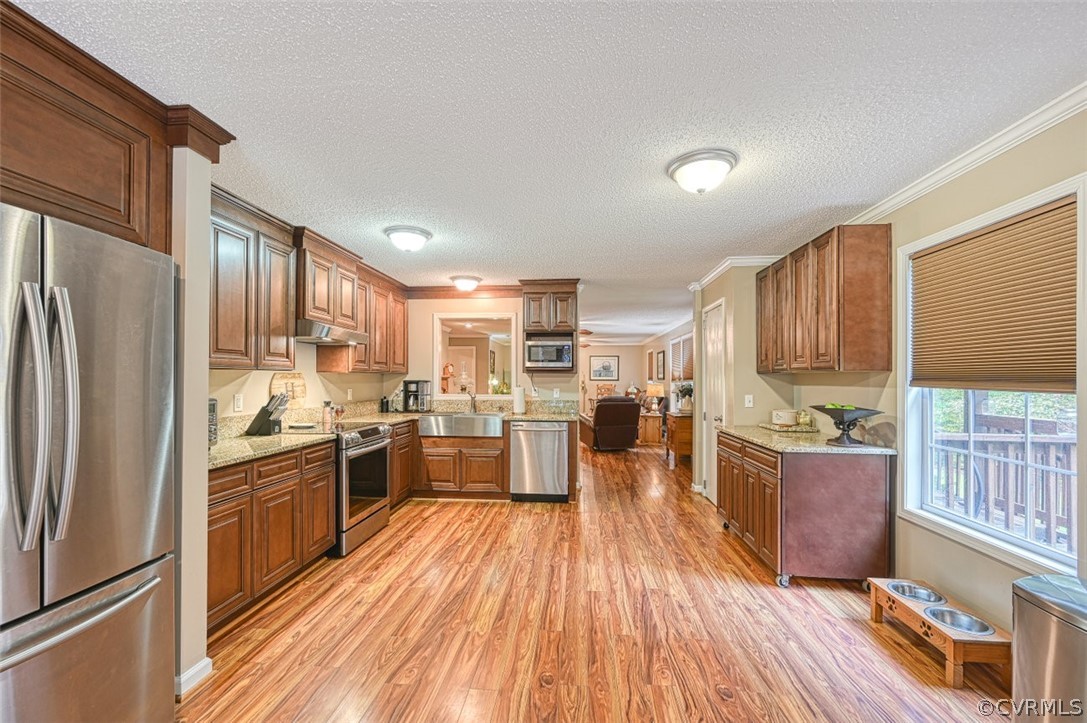 5764 Community House Road Columbia, VA 23038 - Photo 27 of 48 a kitchen with a refrigerator a stove top oven a sink dishwasher and wooden cabinets