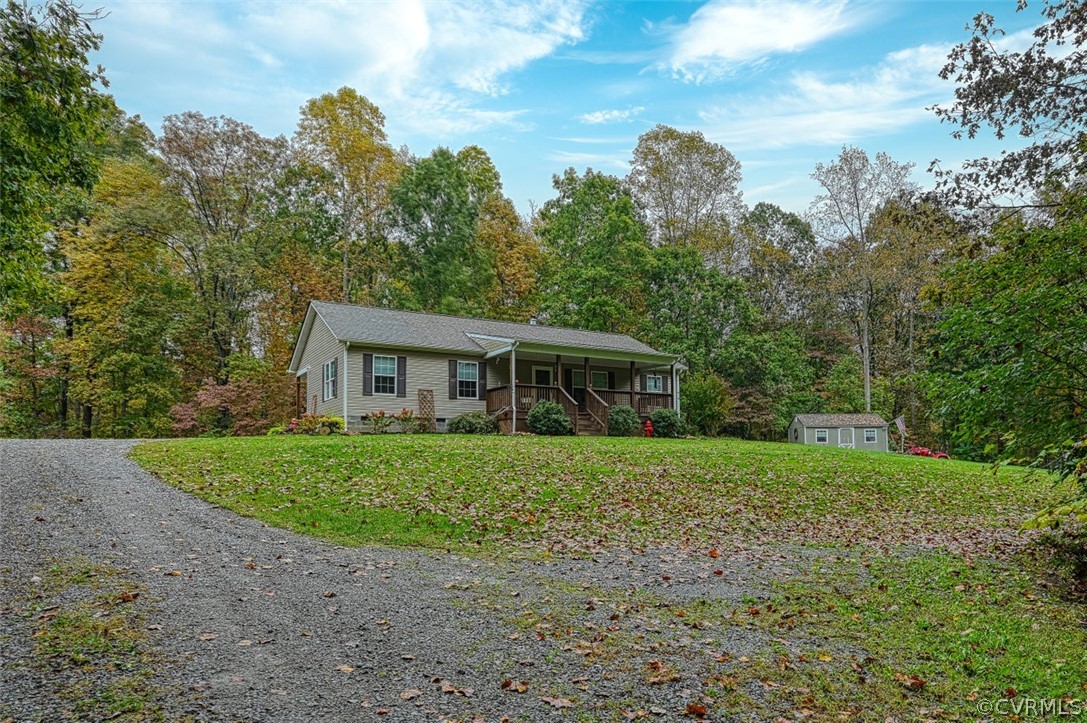 5764 Community House Road Columbia, VA 23038 - Photo 3 of 48 a front view of a house with garden