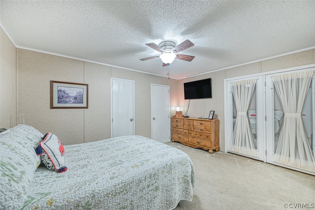 5764 Community House Road Columbia, VA 23038 - Photo 36 of 48 a bedroom with a bed and a chandelier