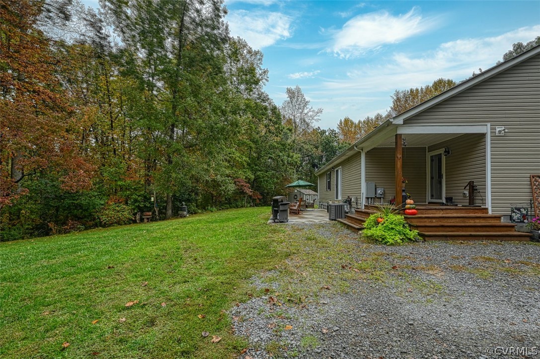 5764 Community House Road Columbia, VA 23038 - Photo 7 of 48 a view of a house with backyard sitting area and garden