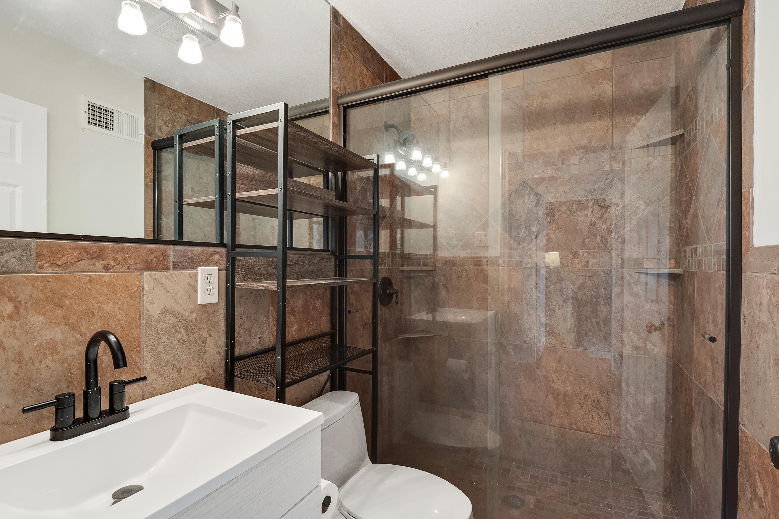 1303 Colonial Road Memphis, TN 38117 - Photo 24 of 38 a bathroom with a sink toilet and shower