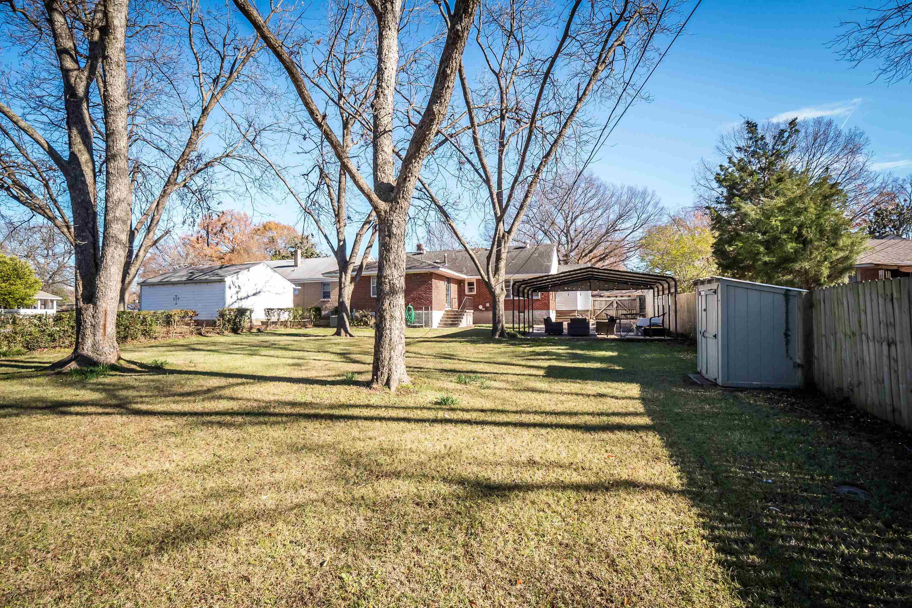 1303 Colonial Road Memphis, TN 38117 - Photo 32 of 38 a view of a swimming pool with a house in the background